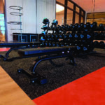 Rubber gym flooring mat installed under fitness equipment