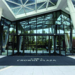 Custom logo entrance mat with Crowne Plaza branding at a hotel lobby