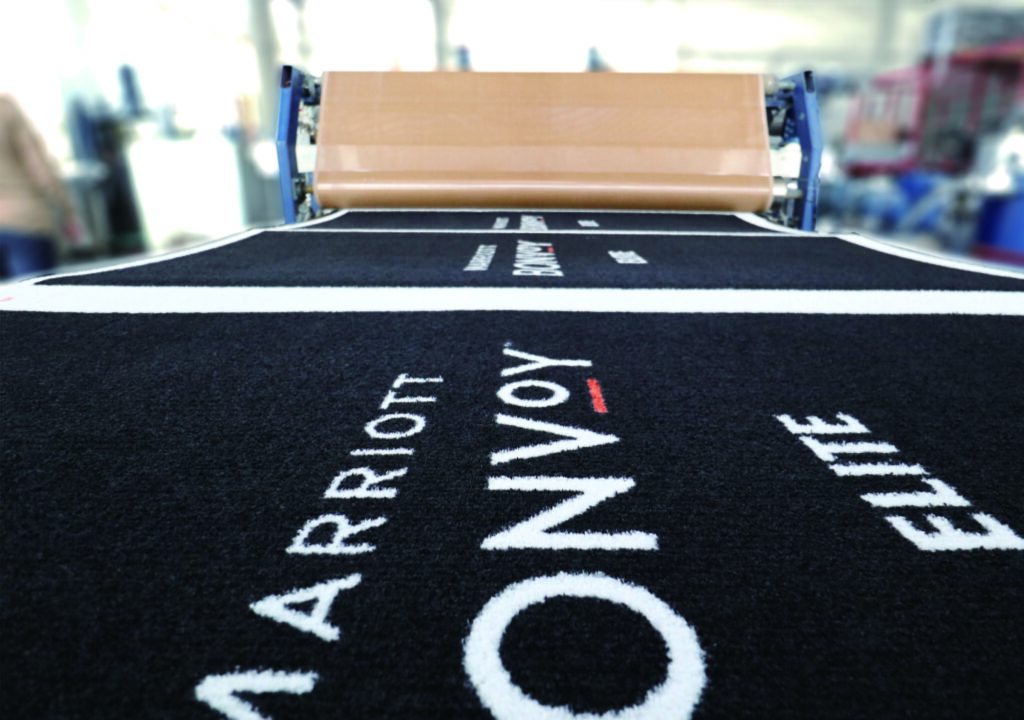 Close-up of a custom-printed logo mat with Marriott Bonvoy branding