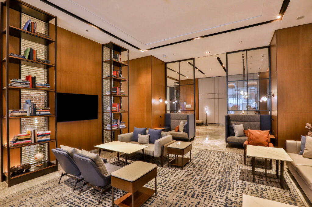 Hotel lobby with a chandelier and warm wood-paneled walls